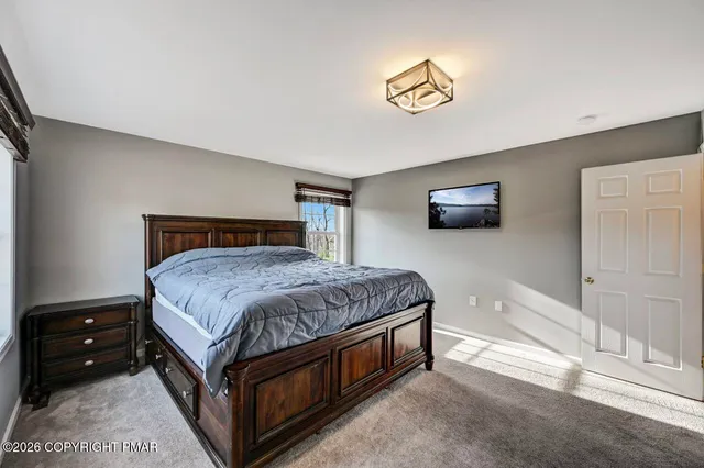 a bedroom with a large bed and a flat screen tv
