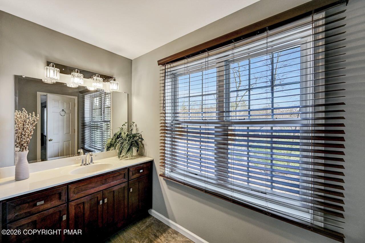 1013 Bear Swamp Road East Stroudsburg, PA 18302 - Photo 30 of 53 a bathroom with a sink and a large mirror