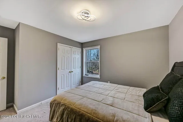 a view of walk in closet with clothes