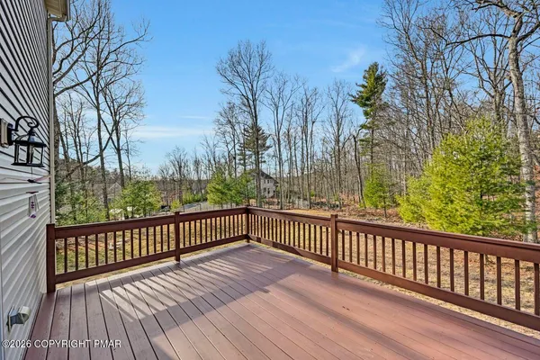a view of stairs and trees with wooden fence