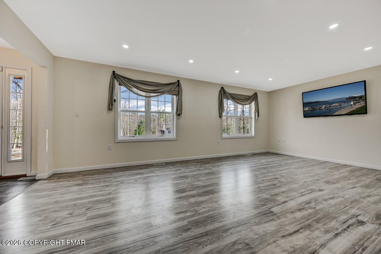 1013 Bear Swamp Road East Stroudsburg, PA 18302 - Photo 5 of 53 a view of an empty room with window and wooden floor