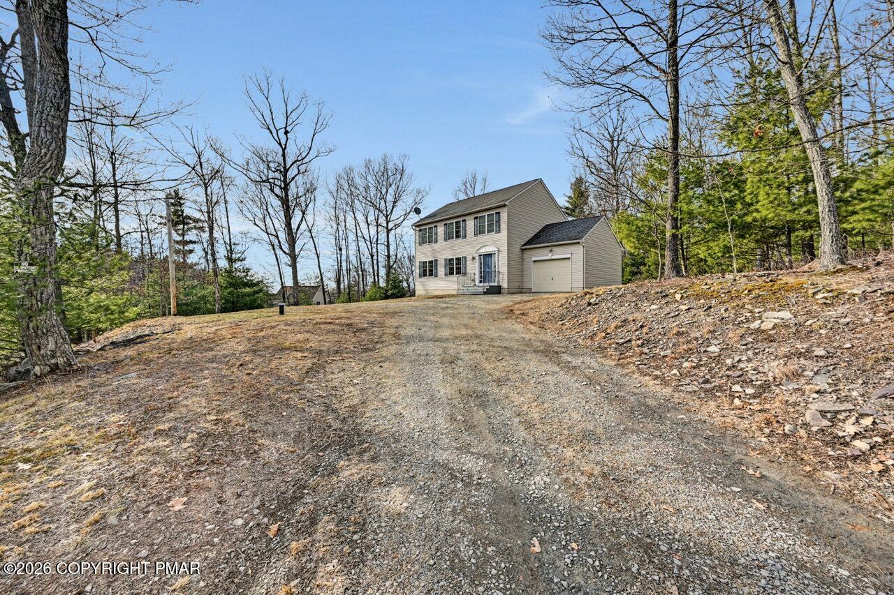 1013 Bear Swamp Road East Stroudsburg, PA 18302 - Photo 51 of 53 a front view of a house with a yard and garage