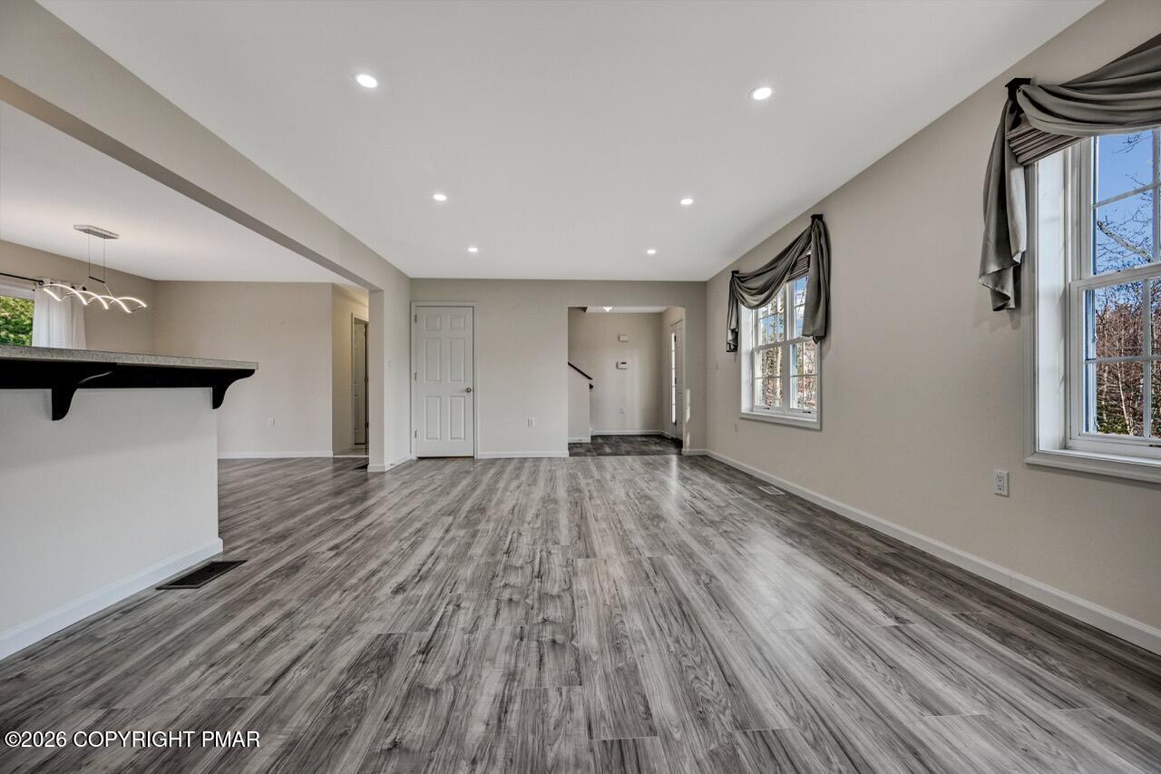 1013 Bear Swamp Road East Stroudsburg, PA 18302 - Photo 6 of 53 a view of empty room with wooden floor and fan