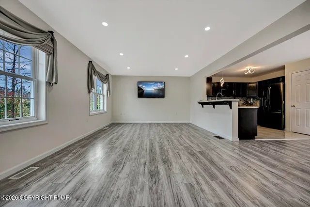 a view of a kitchen with a sink and a refrigerator