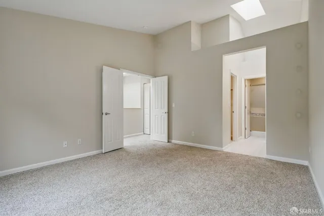 a view of an empty room and closet area