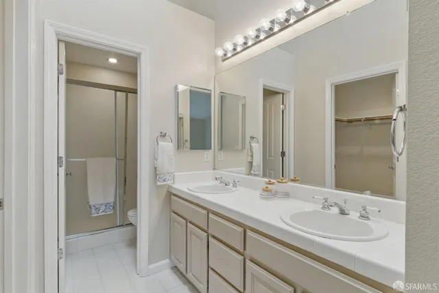 a bathroom with a double vanity sink and a mirror
