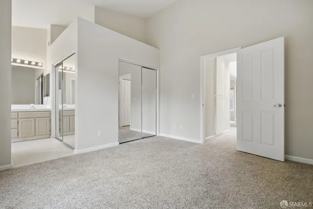 a view of a room with white walls and cabinet