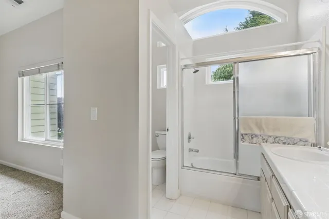 a bathroom with a tub shower and sink