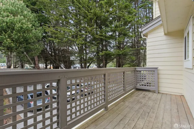 a view of a balcony with wooden floor