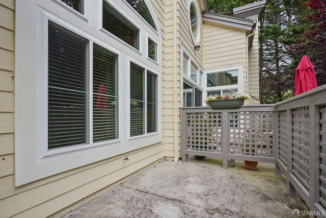 a view of a house with a window and wooden fence
