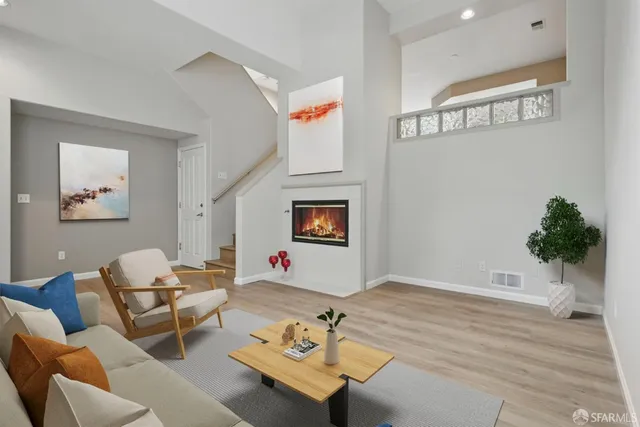 a living room with furniture and wall paintings