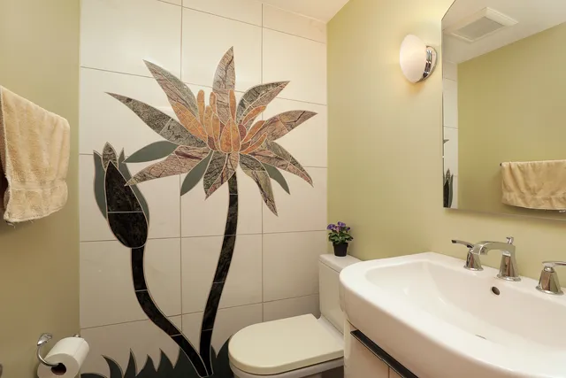 a bathroom with a sink mirror and toilet