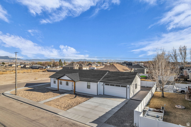 520 East 450th Street North Delta, UT 84624 - Photo 4 of 48 View of front of property featuring driveway, a garage, a residential view, and a shingled roof
