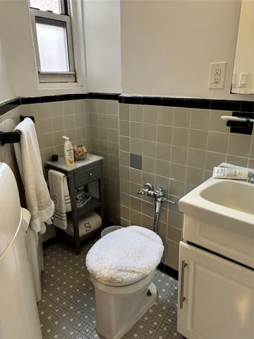a bathroom with a toilet a sink and a mirror