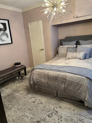 a bedroom with a bed a window and a ceiling fan