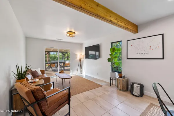 a living room with furniture and a potted plant