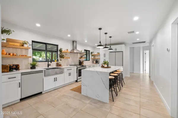 a kitchen with cabinets and chairs