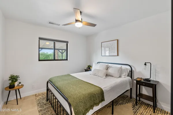 a bedroom with a bed and a table