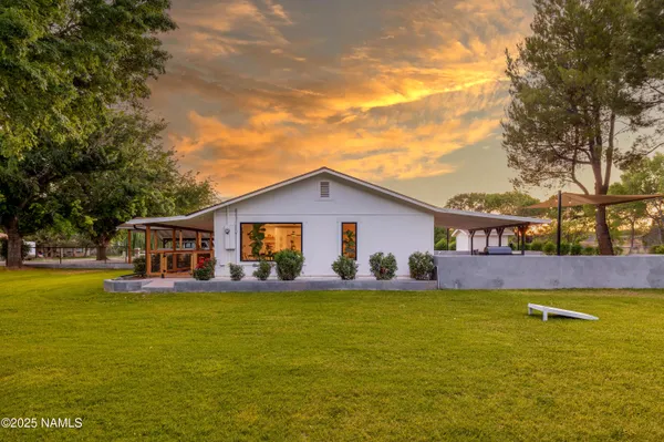 a view of a house with a yard and sitting area