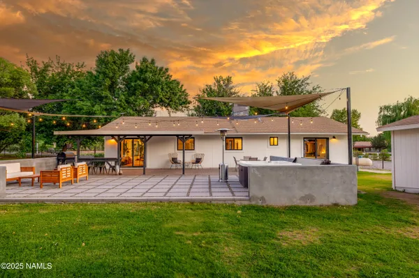 a view of a house with pool and a yard