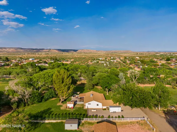 an aerial view of a house with swimming pool garden and patio
