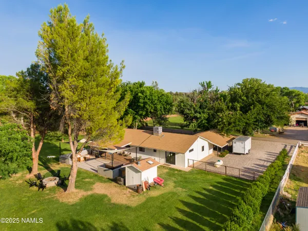an aerial view of a house with swimming pool garden and mountain view