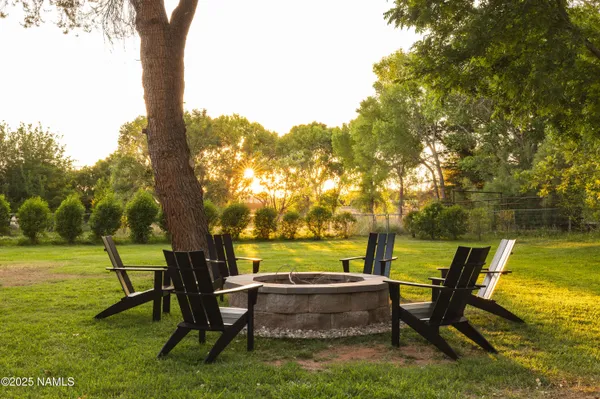 a view of swimming pool with table and chairs