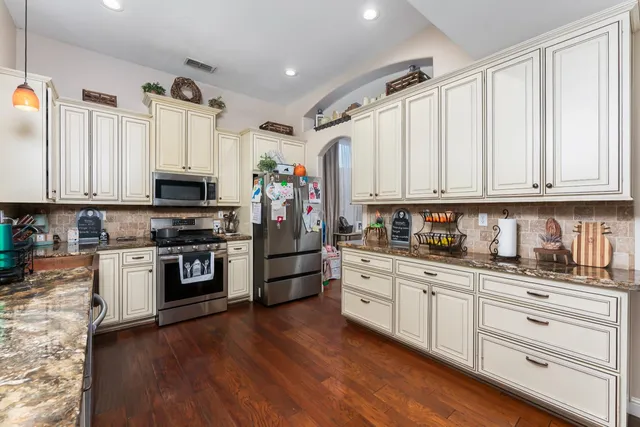 a kitchen with a sink and a refrigerator