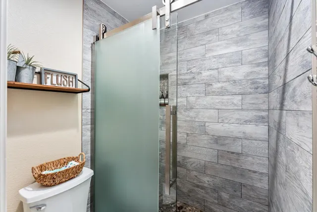 a bedroom with furniture and flat screen tv