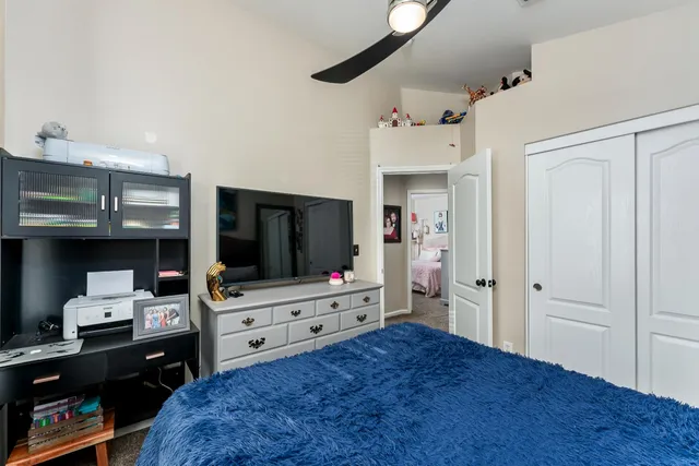 a bedroom with a bed and a flat screen tv