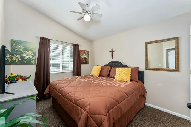 a bedroom with a bed and a couch