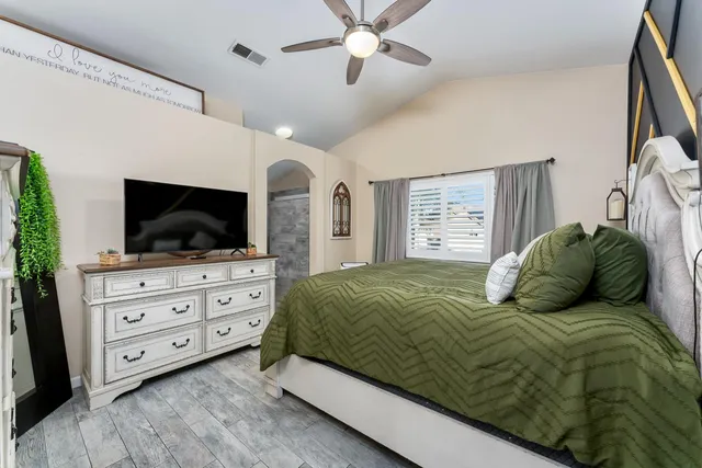 a bedroom with a bed and a chandelier