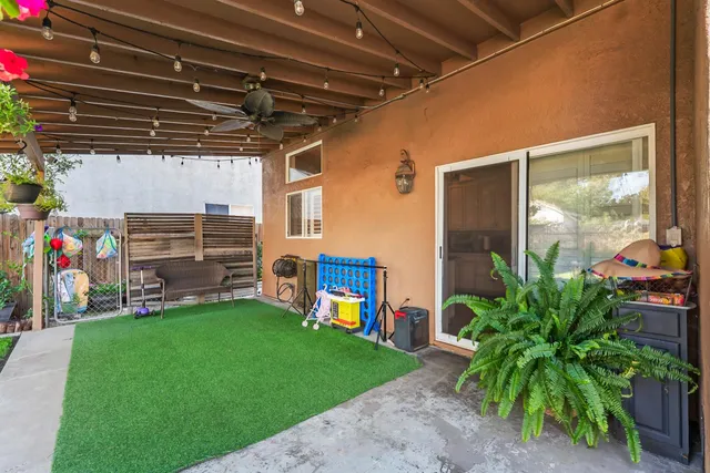 a view of a house with backyard and sitting area