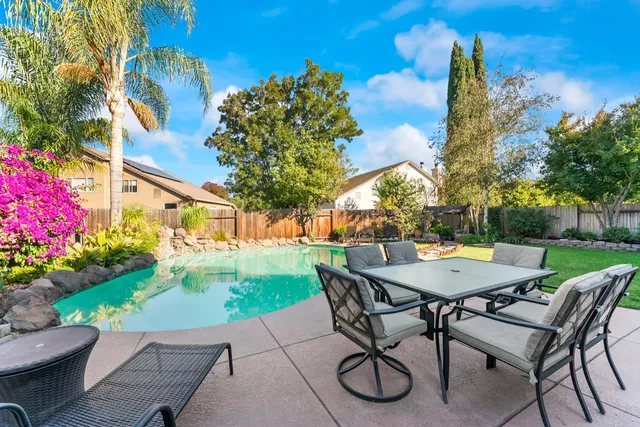 a view of a house with swimming pool yard and patio