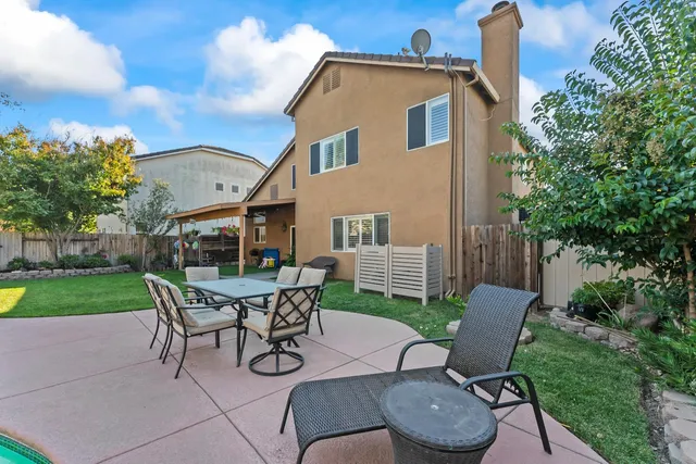 a view of a house with swimming pool yard and patio