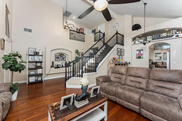 a living room with furniture and wooden floor