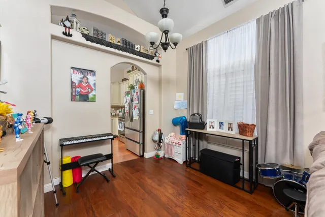 a living room with furniture hardwood floor and a chandelier