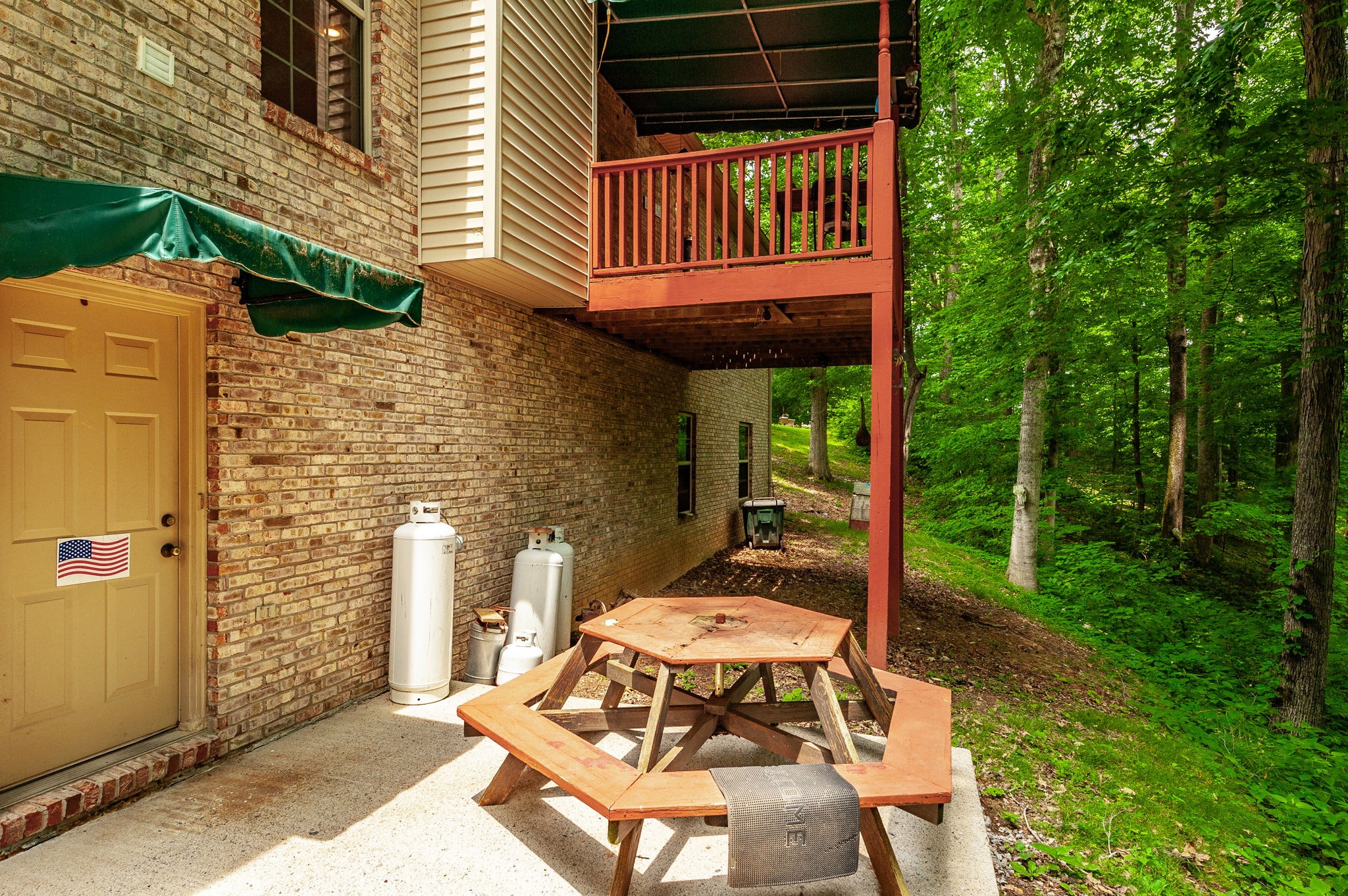6513 North Mt Pleasant Road Greenbrier, TN 37073 - Photo 16 of 54 a view of a patio with a table chairs and a potted plant