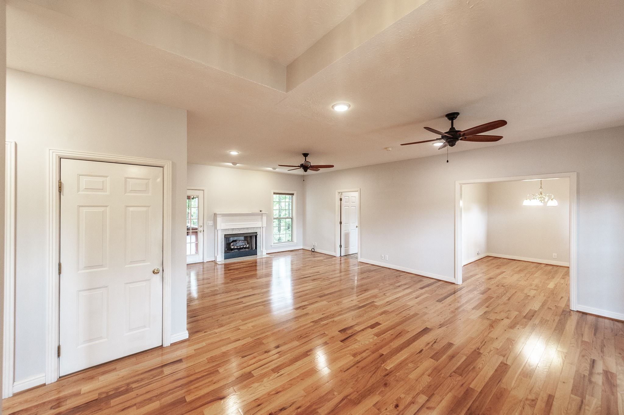 6513 North Mt Pleasant Road Greenbrier, TN 37073 - Photo 21 of 54 an empty room with wooden floor ceiling fan and windows
