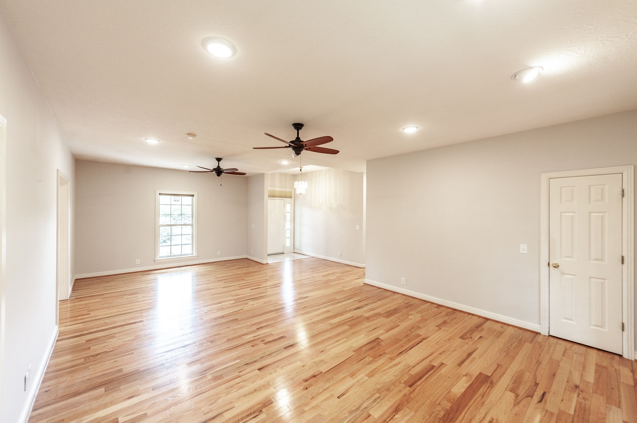 6513 North Mt Pleasant Road Greenbrier, TN 37073 - Photo 28 of 54 an empty room with wooden floor a ceiling fan white walls and windows