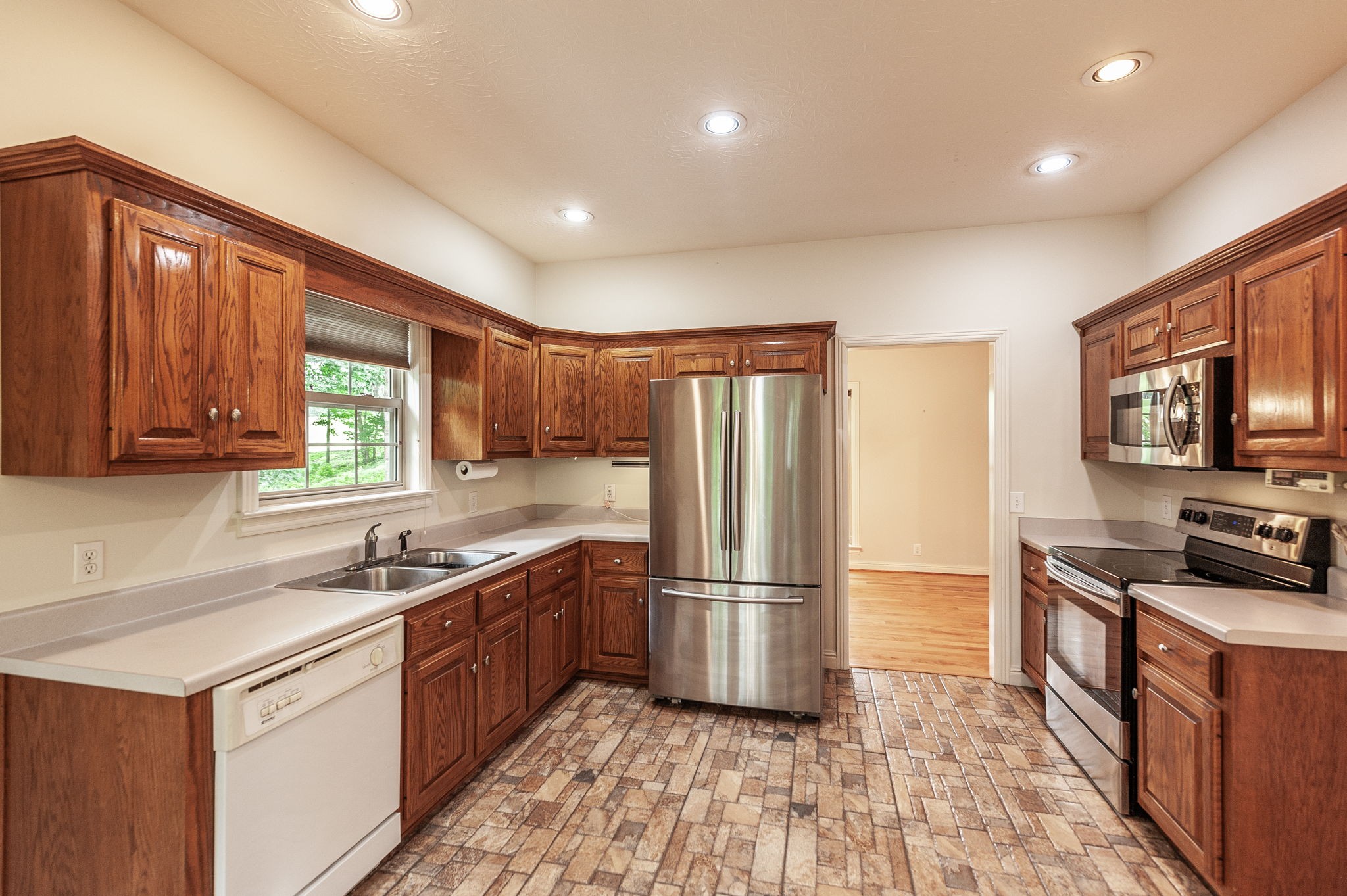 6513 North Mt Pleasant Road Greenbrier, TN 37073 - Photo 31 of 54 a kitchen with wooden cabinets and stainless steel appliances