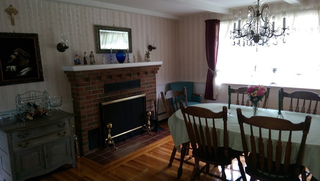954 Chase Road Lunenburg, MA 01462 - Photo 13 of 27 a view of a dining room with furniture and chandelier