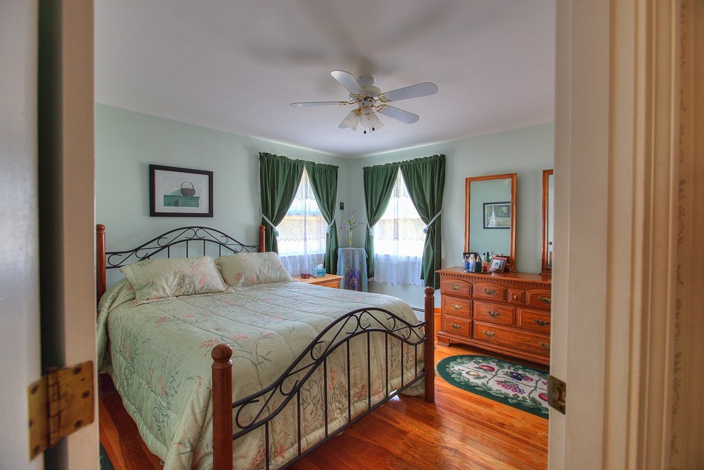 954 Chase Road Lunenburg, MA 01462 - Photo 14 of 27 a bedroom with furniture a bed and a chandelier
