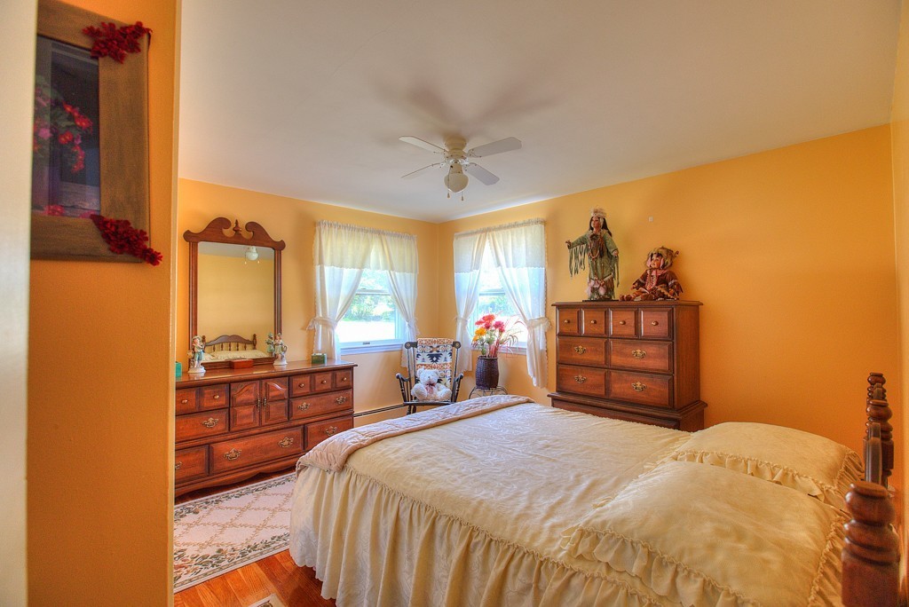 954 Chase Road Lunenburg, MA 01462 - Photo 15 of 27 a bedroom with a bed dresser and a window