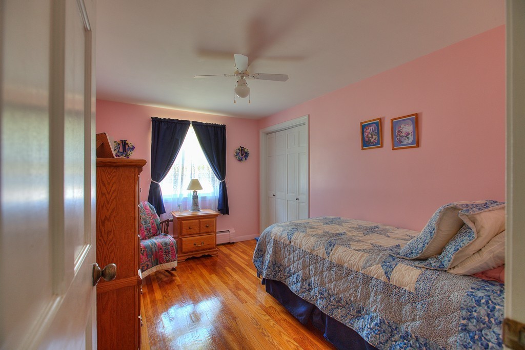 954 Chase Road Lunenburg, MA 01462 - Photo 16 of 27 a bedroom with a bed and a dresser next to a window