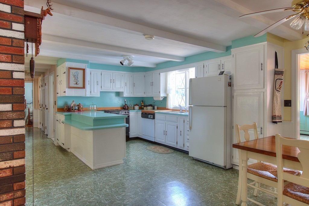 954 Chase Road Lunenburg, MA 01462 - Photo 7 of 27 a kitchen with refrigerator and cabinets