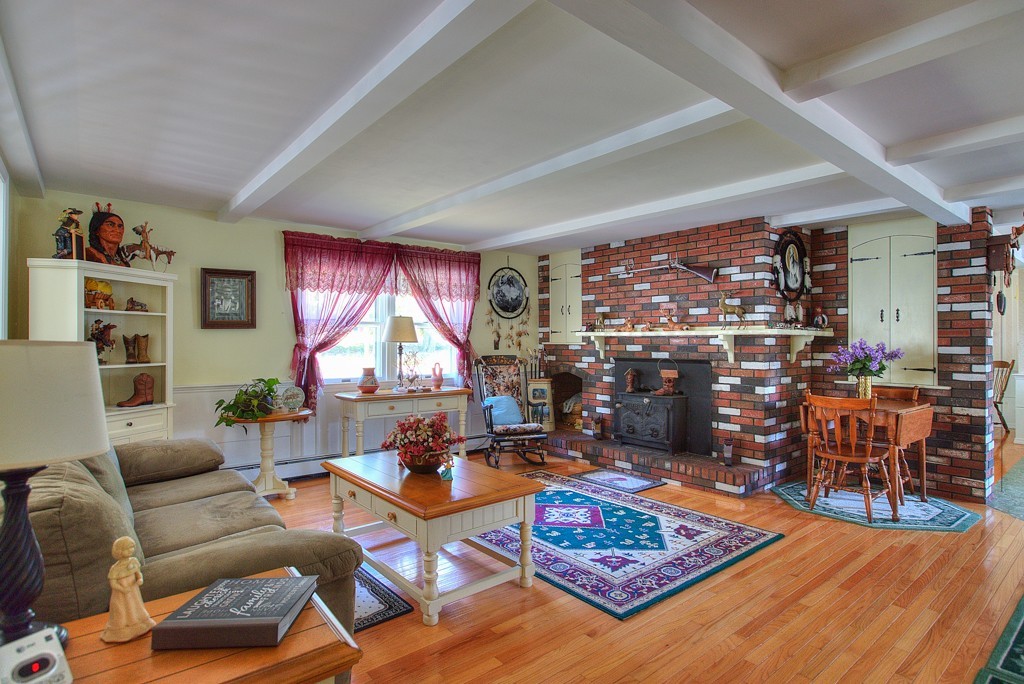 954 Chase Road Lunenburg, MA 01462 - Photo 9 of 27 a living room with furniture a rug and a large window