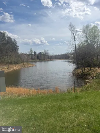 a lake view with a bench next to a lake