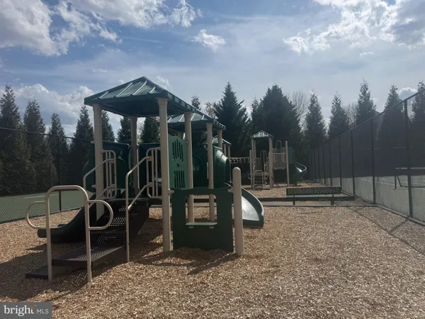 a childrens park with lots of swings and slides