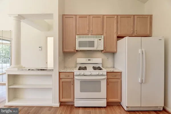 a kitchen with cabinets appliances a sink and a window